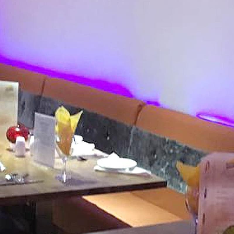 Guests seated at tables in the restaurant on a busy evening.