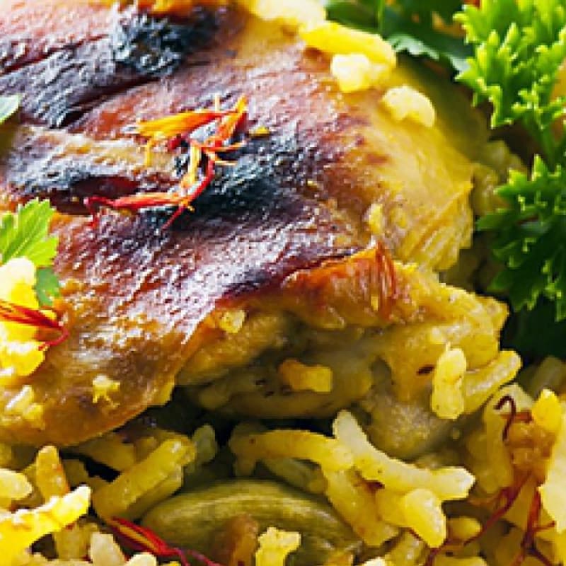Tandoori chicken tikka, charred from the clay oven, with pilau rice.